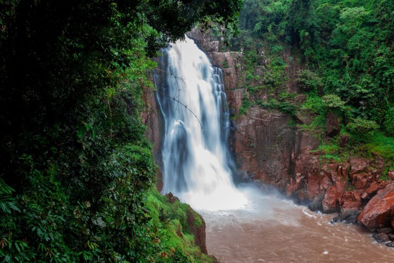 Haew Narok Waterfall plunging down a tall cliff into thick rainforest